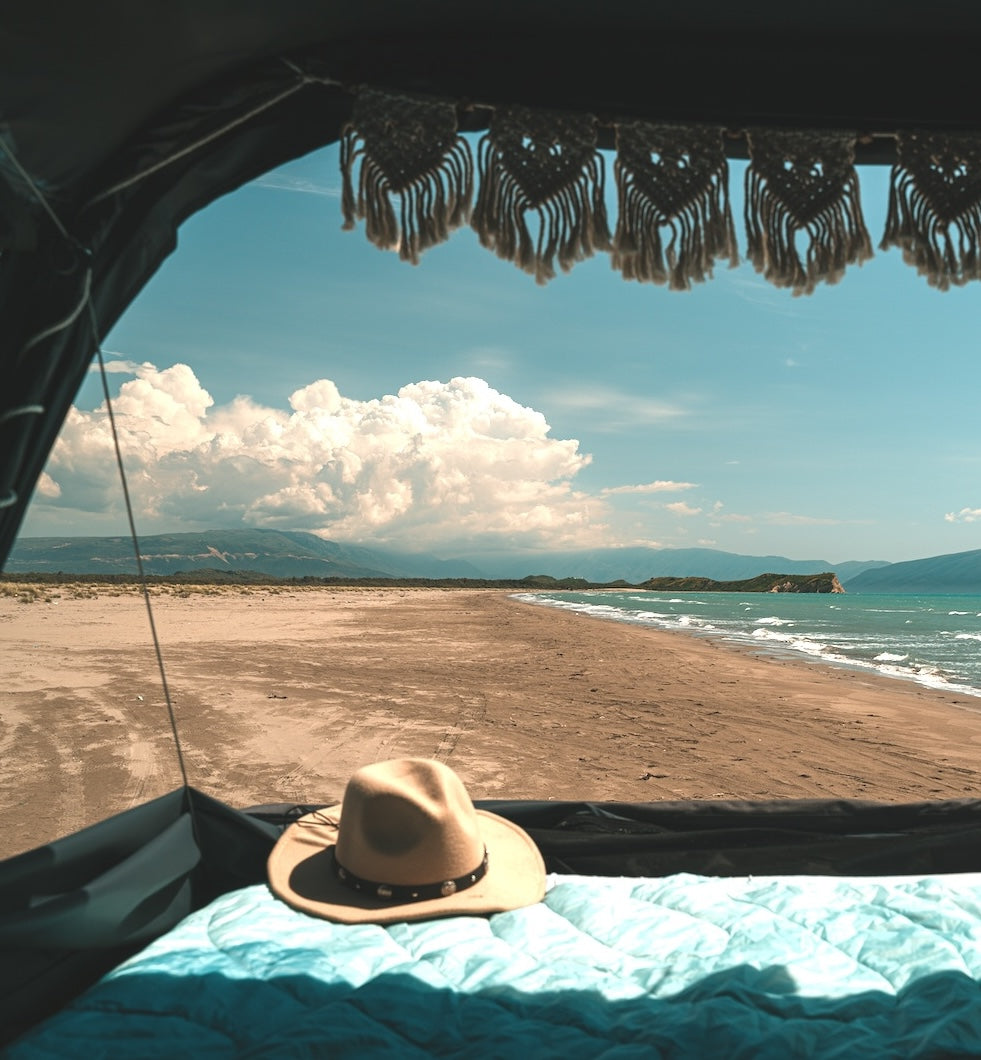Open Panorama Mode of a Roof Space rooftop tent. With a view of the beach and sea.