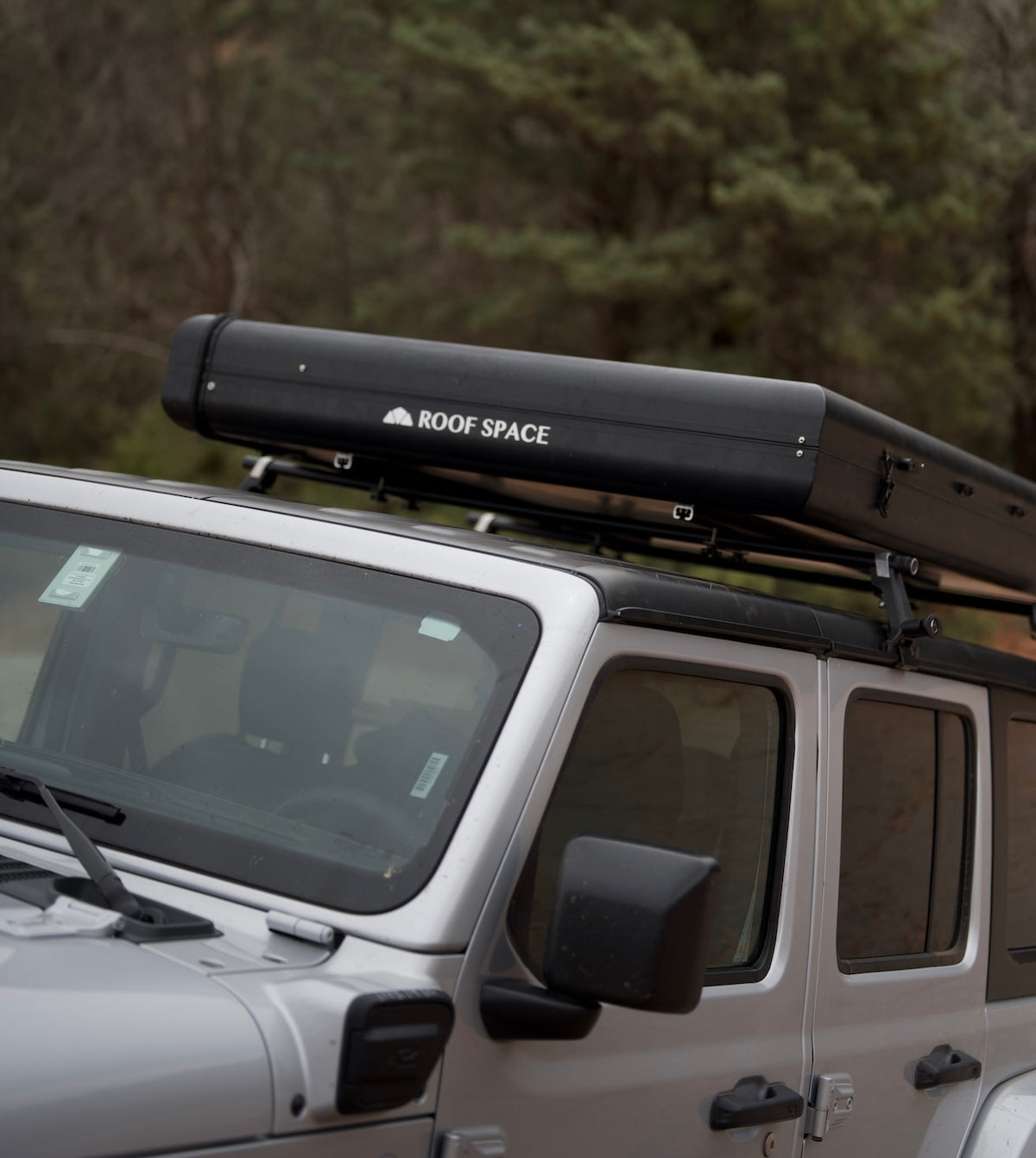 Closed Roof Space rooftop tent case mounted on Jeep Wrangler.