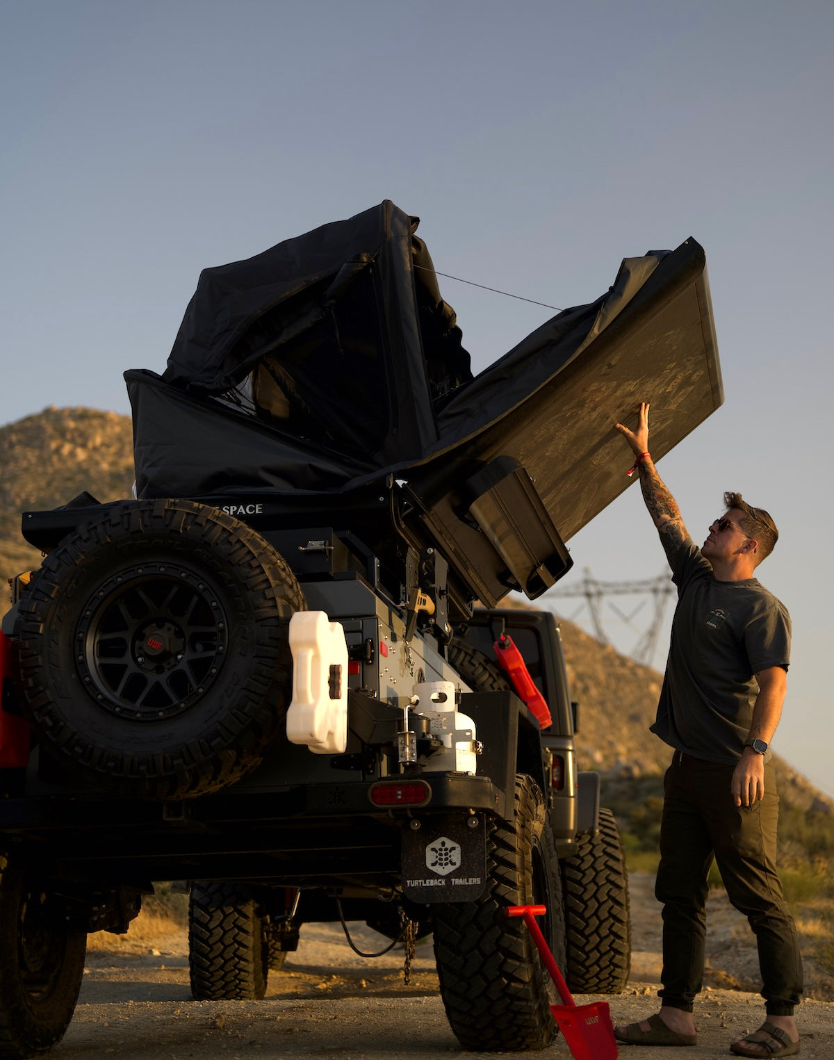 One person setting up a Roof Space tent on an off-road trailer.