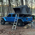 Roof Space 2 rooftop tent set up in the woods on a Jeep Wrangler.